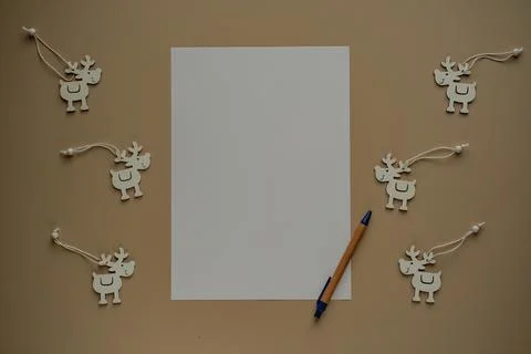 Blank sheets of paper with copy space for text, pen and deers made of wood .. Stock Photos
