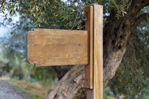 Blank signpost board. Old empty wooden information guidepost on the way Stock Photos
