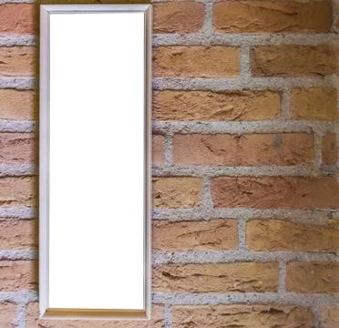 Blank small long white rectangular shaped picture frame hanging on a brick wa Stock Photos