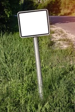 A blank small road sign next to the highway. Фото