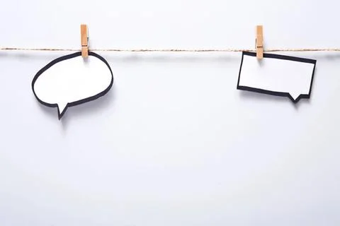 Blank speech bubbles hanging on a clothesline Stock Photos