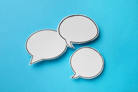 Blank speech bubbles on light blue background, top view. Space for text Stock Photos