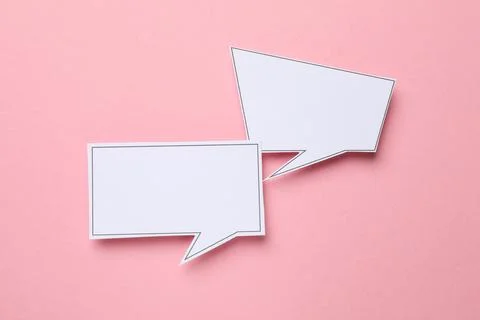 Blank speech bubbles on light pink background, top view. Space for text Stock Photos