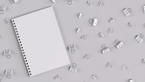 Blank spiral notebook with white binder clips on white table Stock Illustration