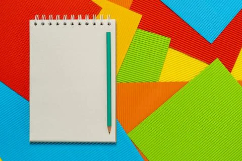 Blank spiral notepad on the colored embossed paper sheets Stock Photos