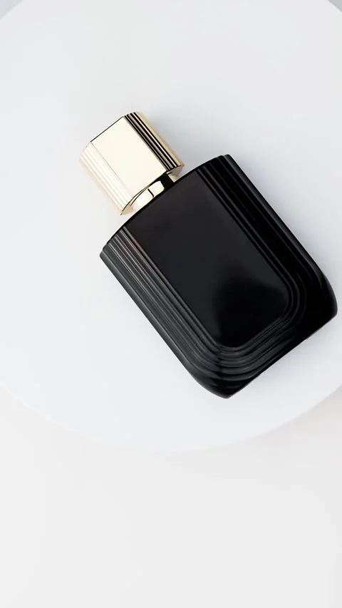Blank spray bottle of perfume rotating isolated on white background. Golden cap Stock Footage 329932148