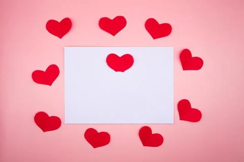 Blank square card framed by red hearts on pink background Stock Photos