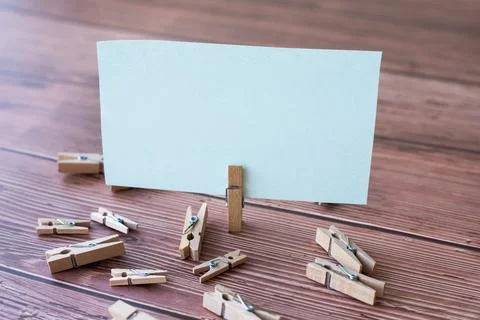 Blank Square Note Surrounded By Laundry Clips Showing New Meaning. Empty Piece Foto stock