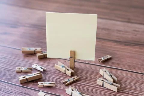 Blank Square Note Surrounded By Laundry Clips Showing New Meaning. Empty Piece Foto stock