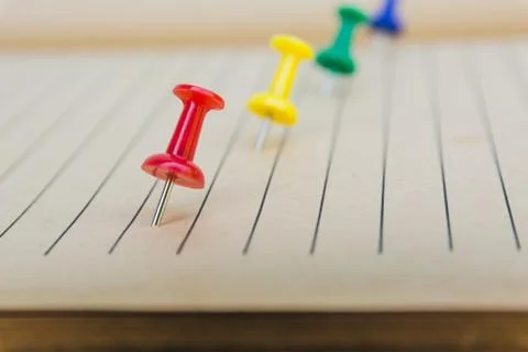 Blank squared note pages with pin. Note paper stuck with pin. Stock Photos