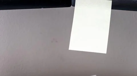 A blank sticky note attached to a computer monitor represents a missed message Stock Photos