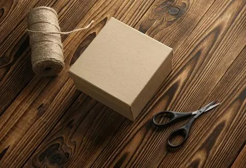 Blank sticky note pad with scissors and twine on wooden table Stock Photos