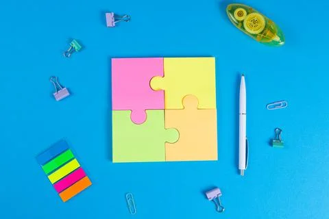 Blank sticky notes in the form of a puzzle on a blue background, space for text Stock Photos
