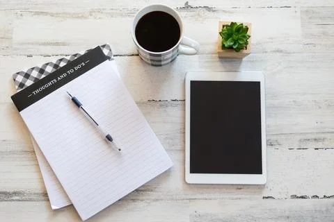 Blank tablet and notepad on modern desktop Stock-Fotos