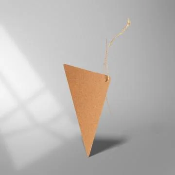 A blank triangular brown kraft paper tag mockup floating with a string agai.. Stock Photos