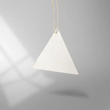 Blank triangular white paper price tag hanging from a rustic twine string aga Stock Photos