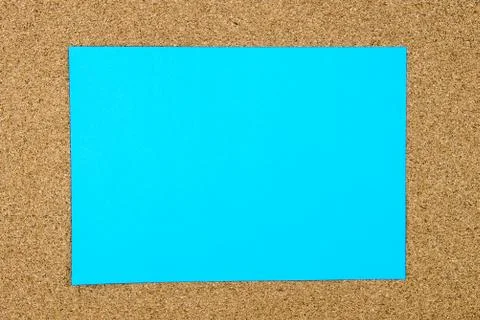 Blank turquoise paper note over cork board Stock Photos