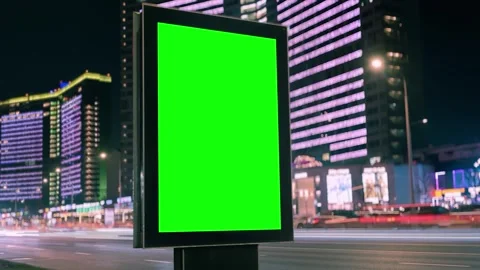 Blank vertical billboard with green screen on a busy city street at night Stock Footage 346076658