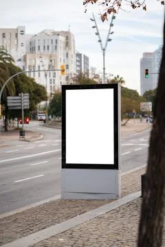 Blank vertical digital screen display mockup in city street, advertising space Stock Photos