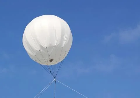 A blank white balloon with space for text, over a clear blue summer sky Stock Photos