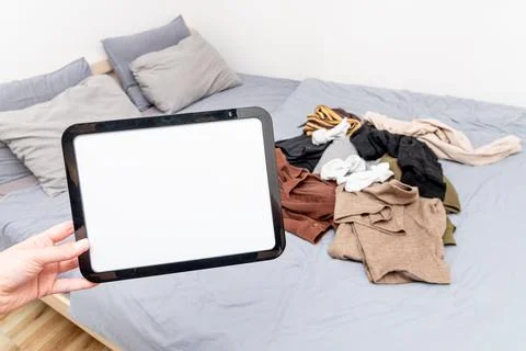 Blank white board notebook with copy space for text on pile clothes backgroun Stockfoto's