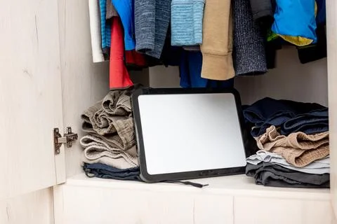 Blank white board notebook with copy space on open door wardrobe background Stock Photos