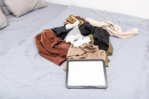 Blank white board notebook with copy space for text on pile clothes backgroun Photos