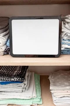 Blank white board notebook with copy space on sheets shelf wardrobe backgroun Stock Photos