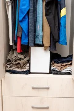 Blank white board notebook with copy space on open door wardrobe background Stock Photos