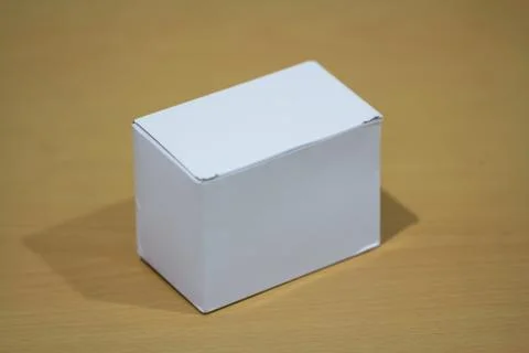 Blank white box on a table Фото