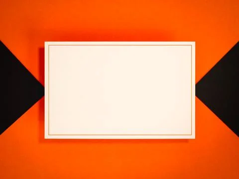 Blank white card mockup with thin orange border centered on bold geometric .. Stock Photos