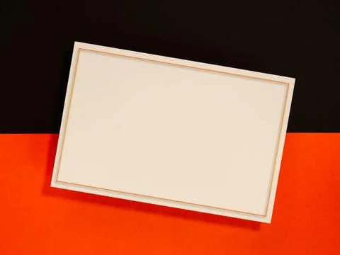 Blank white card mockup with thin orange border, and soft shadow on bold bl.. Stock Photos