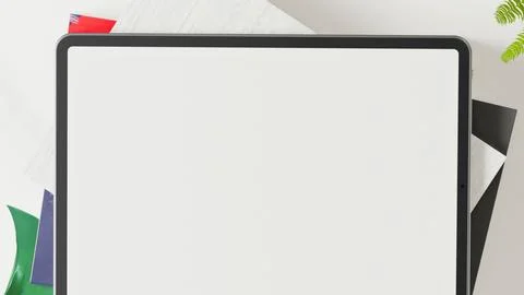 Blank white digital tablet screen with colorful office supplies Stock Photos