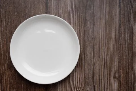 Blank white dish or empty plate on  rustic wooden table. top view. space for  Stock Photos