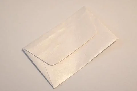 Blank white envelope on a light surface Stock Photos