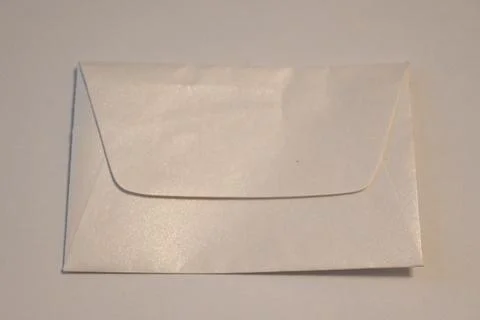 Blank white envelope on a neutral surface Stock Photos