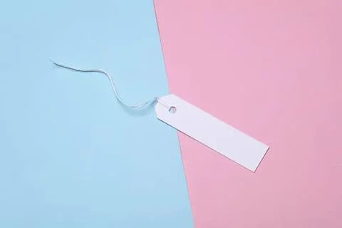 Blank white label with string on pastel pink and blue background Stock Photos