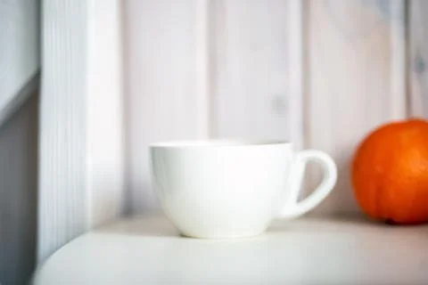 Blank white mug on kitchen table. Stock Photos