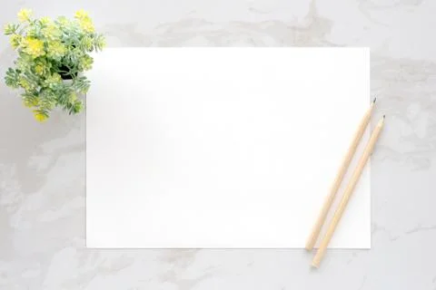 Blank white note paper and pencils on white marble background, flat lay, top Stock Photos