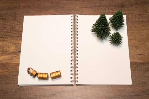 Blank white notebook with green pine tree and golden train Stock Photos