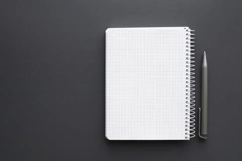 Blank white notebook with pen over grey desktop Stock Photos