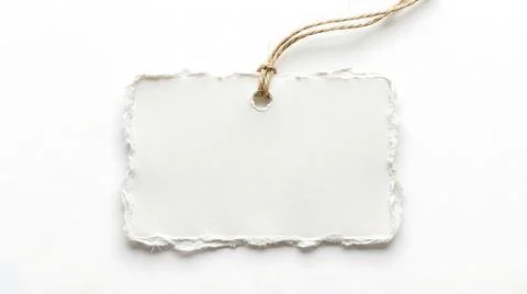 Blank white paper tag with torn edges and string isolated on a white backgrou Stock Photos