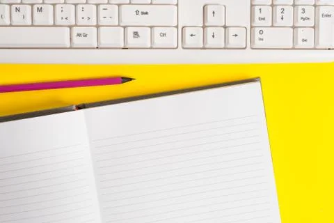 Blank white paper for textual messages. Copy space on notebook above yellow Stock Photos