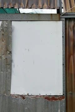 Blank white plastic rectangle frame on rusty greenhouse wall background wit.. Stock Photos