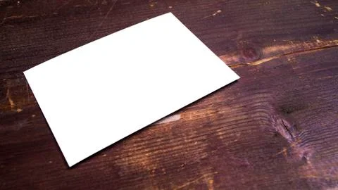 Blank white postcard template  on a wooden background. Stock Photos
