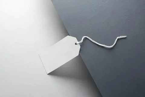 Blank white price tag with string on gray background Stock Photos