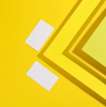Blank white rectangular business card on creative yellow background from shee 스톡 사진