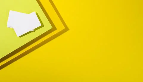 Blank white rectangular business card on creative yellow background from shee Fotos de archivo