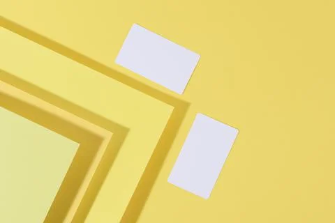Blank white rectangular business card on creative yellow background from shee 스톡 사진