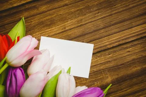 Blank white rectangular card is lying atop wooden tabletop in flat-lay, with 库存照片